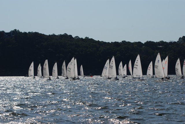 Masters fleet sailing in silhouette at sunset